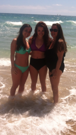 [my mom, sister (left), and I (center), looking tan in the ocean.]